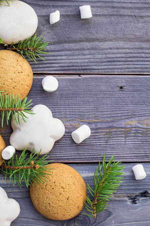Christmas border with gingerbread, marshmallow and branch of fir tree.の写真素材