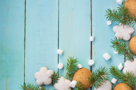 Christmas border with gingerbread, marshmallow and branch of fir tree.の写真素材