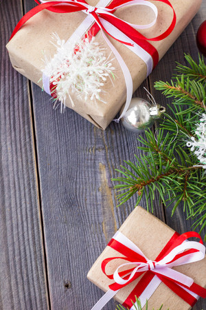 Christmas background with fir tree and decorations and gift boxes on wooden board.の写真素材