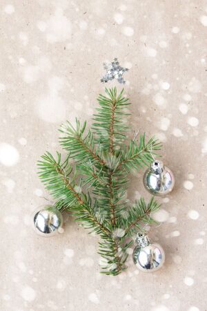 Christmas tree made of fir branches and silver decorations with snow. Christmas, winter, new year concept. Flat lay, top view.の写真素材
