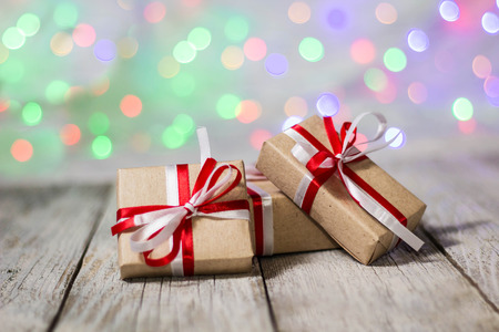 Christmas gift box against bokeh background. Holiday greeting card.の写真素材