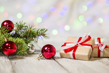 Gift boxes and colorful decorated Christmas tree on bokeh background with copy space.の写真素材
