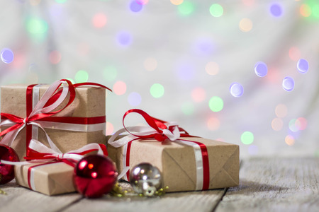 Christmas gift box with balls against bokeh background. Holiday greeting card.の写真素材