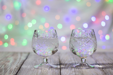 two glasses of champagne against bokeh lights background.の写真素材
