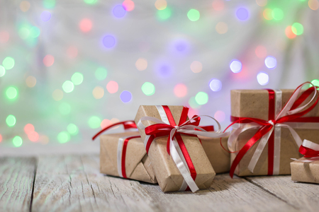 Christmas gift box against bokeh background. Holiday greeting card.の写真素材