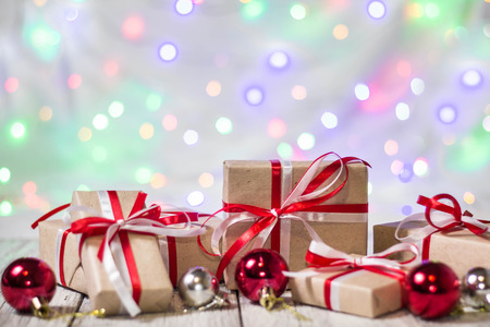 Christmas gift box with balls against bokeh background. Holiday greeting card.の写真素材
