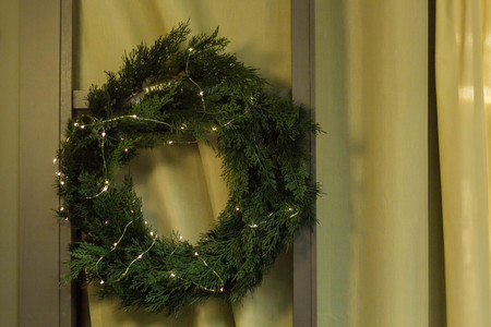 Christmas wreath with lights garland . Homemade creative handmade decor for home.の写真素材