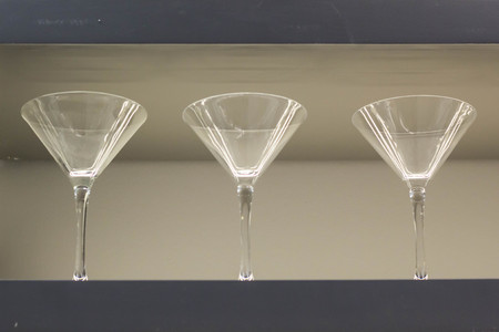 Row of empty wine glasses on bar counter.の写真素材