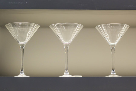 Row of empty wine glasses on bar counter.の写真素材