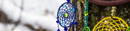 Banner of Colorful Dreamcatcher made of feathers leather beads and ropes, hanging, handmade