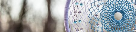 Banner of Dreamcatcher with bat made of feathers leather beads and ropes, hangingの写真素材