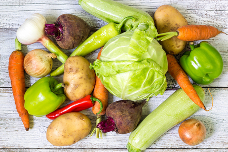 Close up of various colorful raw vegetables on white wooden background. Healthy eating.の写真素材