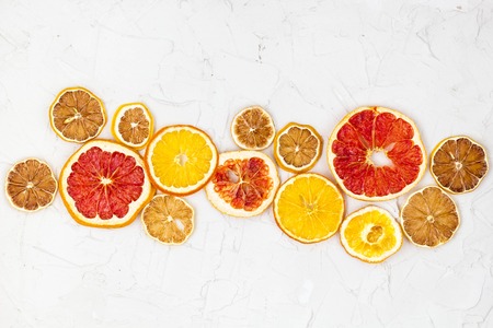 Border of Dried slices of various citrus fruits on white background. Many Orange lemon grapefruit with copyspaceの写真素材