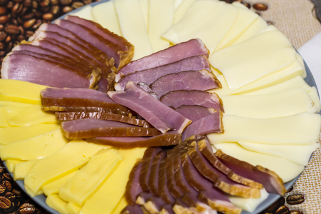 Cutting from cheese and meat products. On a grey dishの写真素材