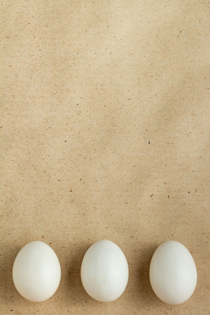 Top view of three white eggs on rustic background with copyspaceの写真素材