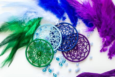 Dream catcher with feathers threads and beads rope hanging. Dreamcatcher handmade on white...