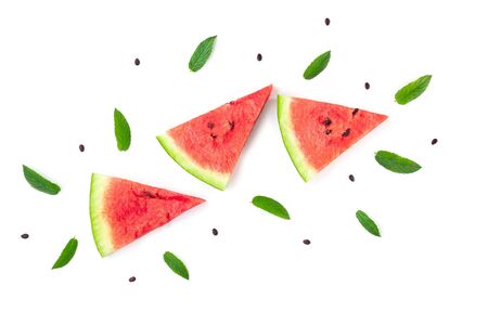 Pattern of slices of watermelon with seeds and mint leaves isolated on white background. Summer conceptの写真素材