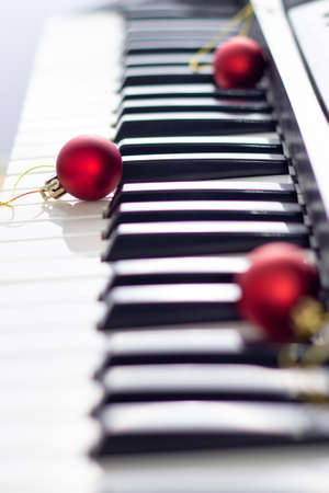 Close up of black and white piano keyboard with christmas ball. New year background with soft focusの写真素材