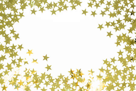 Christmas frame with gold star confetti. Holiday background for New Year on white with copyspaceの写真素材