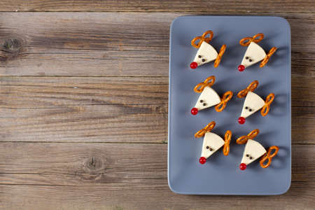 Funny christmas snack in a shapes of deer for kids party. Concept New year food from cheese and...