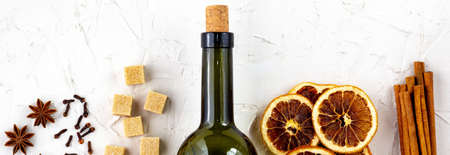 border of Bottle of wine and spice on white background. Ingredients for a mulled wine. Cinnamon,...