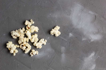 Pile of delicious fresh popcorn on gray stone background. top viewの写真素材