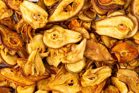 A pile of dried pears in slices. Dried fruit chips. Healthy food. Top viewの写真素材