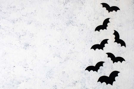 decoration paper bats on a white background. concept for halloween holiday background. Top view with copyspaceの写真素材