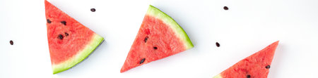 banner of Slices of chopped watermelon with seeds isolated on white background. Summer concept. Flat lay, top viewの写真素材