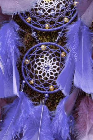 Dream catcher with feathers threads and beads rope hanging. Dreamcatcher handmade in very pei trendy color. background. Color of the year 2022.の写真素材