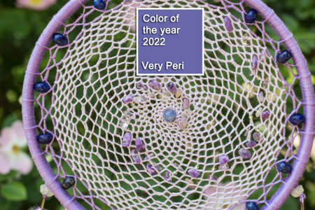 Dream catcher with feathers threads and beads rope hanging. Dreamcatcher handmade in very pei trendy color. background. Color of the year 2022.の写真素材