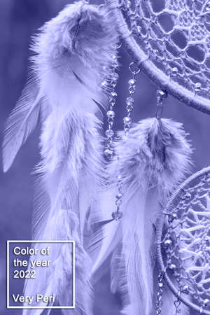 Dream catcher with feathers threads and beads rope hanging. Dreamcatcher handmade in very pei trendy color. background. Color of the year 2022.の写真素材