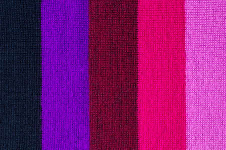 multi colored background. knitted wool fabric texture with colorful stripesの写真素材