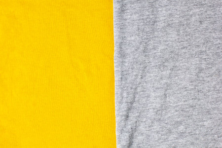 Gray and yellow knitted fabric cotton textured background. Close up with copy space for your designの写真素材