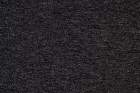 Black knitted fabric cotton textured background. Close up with copy space for your designの写真素材