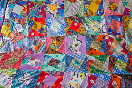 Background of Part of patchwork quilt with flower print. Handmade color blanket in style patchwork....