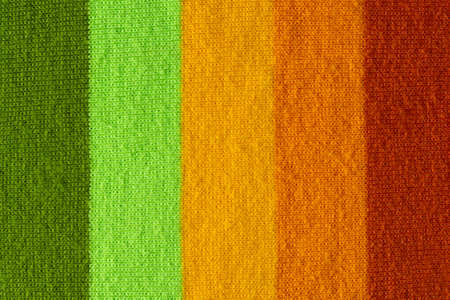 multi colored background. knitted wool fabric texture with colorful stripesの写真素材