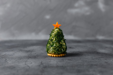 Festive salad of dill cheese and cookies in the form of a Christmas tree. Holiday appetizer in the form of christmas treeの写真素材