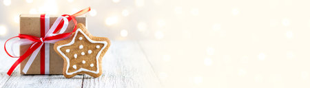banner of Gingerbread star and box of gift on bokeh lights background. Festive xmas background....