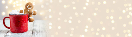 banner of a red cup of winter hot drink with marshmallows and gingerbread man on a white wooden...