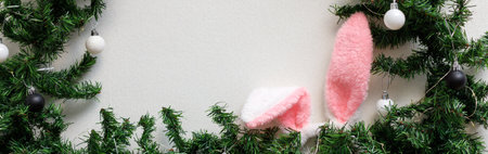 banner of Rabbit ears in the christmas tree on white background. Happy Chinese new year of the...