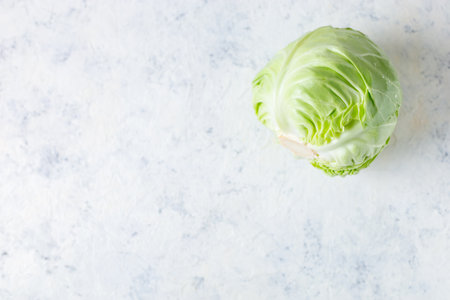 Fresh raw whole cabbage on white table background. Organic healthy food. top view with copy spaceの写真素材