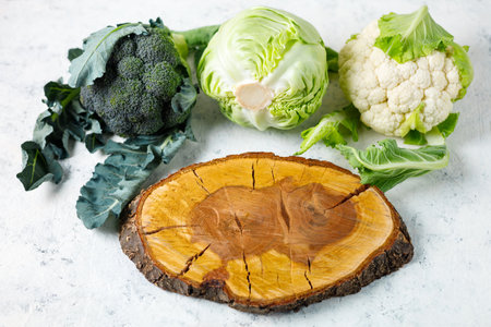 Fresh farm cabbages on white table background. Green raw vegetables with cutting board. top view. copy spaceの写真素材