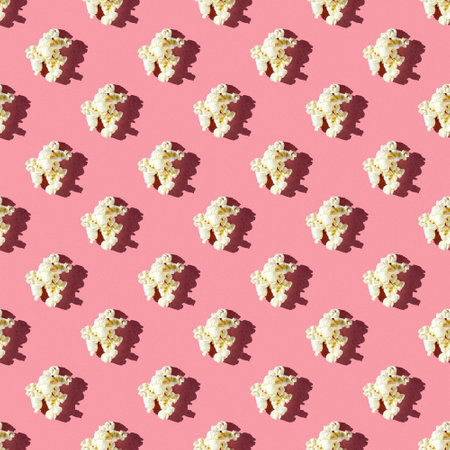 seamless pattern of tasty single popcorn on a pink background with hard lightの写真素材