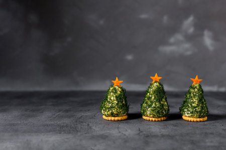 Festive salad of dill cheese and cookies in the form of a Christmas tree. Holiday appetizer in the...