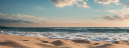Close-up of sea waves touching the shore at sunset, with golden sunlight reflecting on the waterの素材