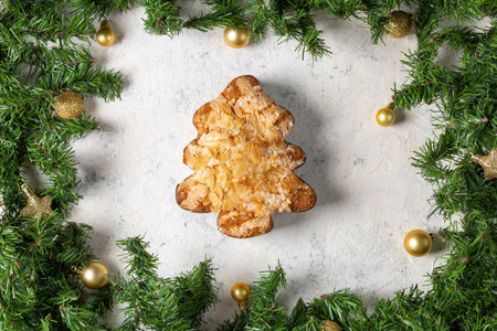 Delicious almond christmas cake with festive evergreen decoration and golden ornaments.の写真素材