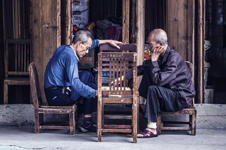 July 16, 2016 old city street, Shantou, China, old people playing chess