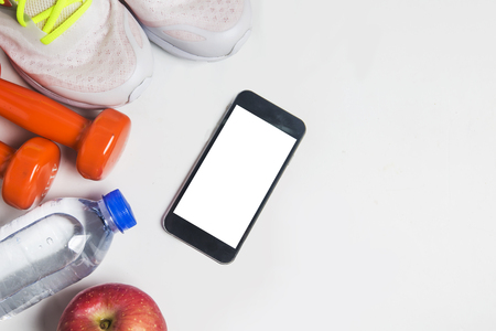 Fitness background with bottle of water, dumbbells and smartphone. View from aboveのeditorial素材