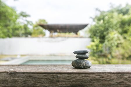 Different pebbles are standing successively near the poolの写真素材